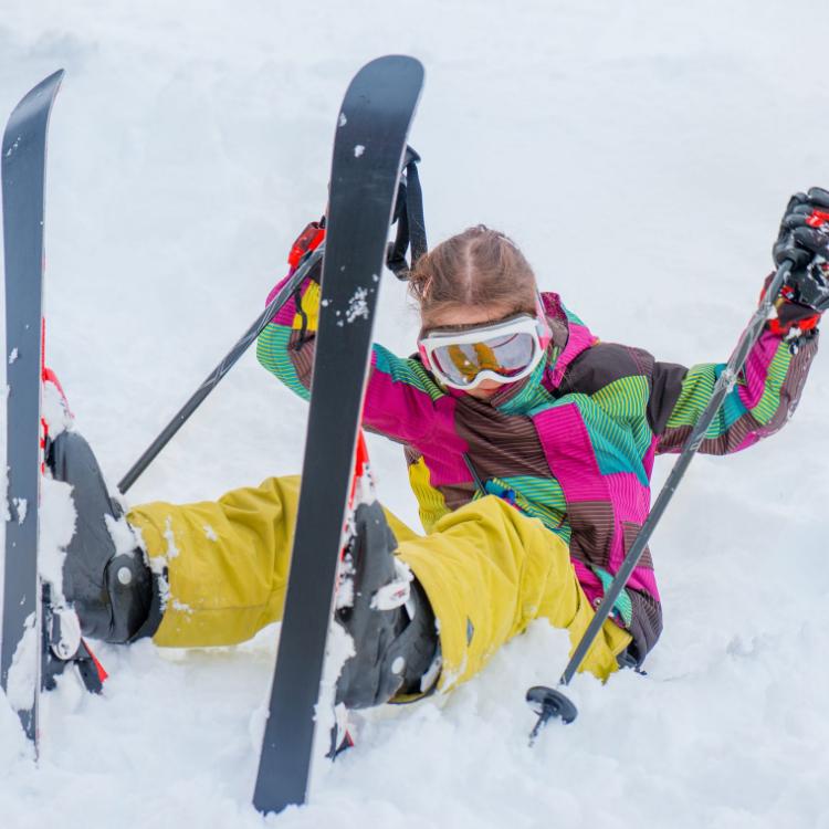 66708475 - happy kid sitting in snow with skis on