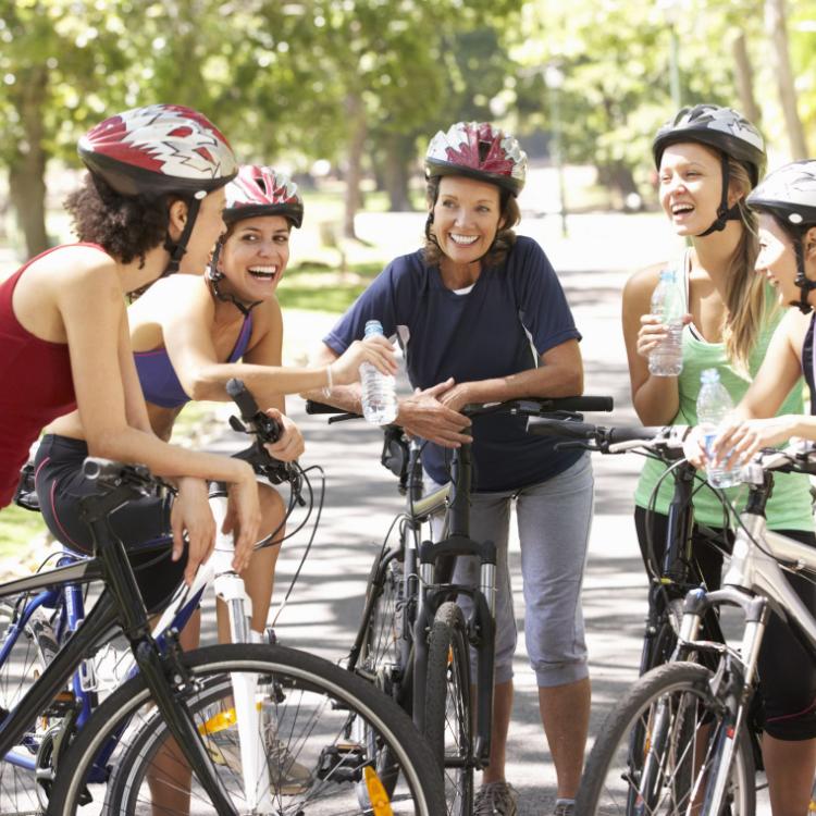 group of women resting during cycle ride through park