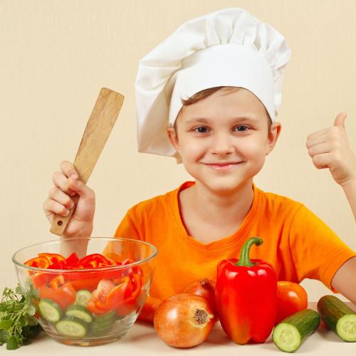 51760880 - little funny chef shows how to cook a vegetable salad