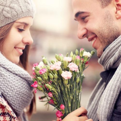 33006659 - a picture of a man giving flowers to his lover on a winter day