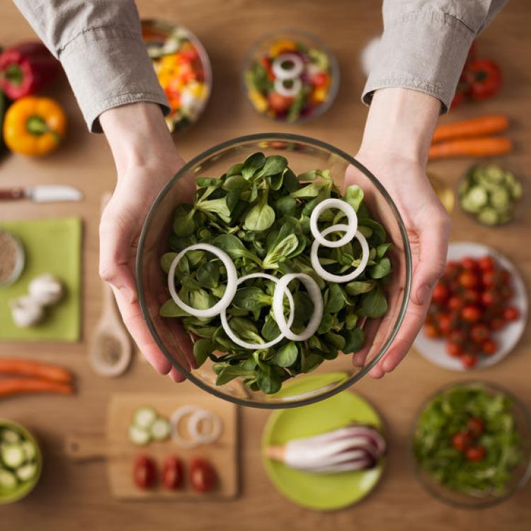 39363732 - hands holding an healthy fresh vegetarian salad in a bowl, fresh raw vegetables