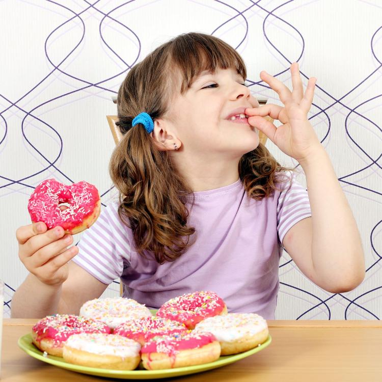 46374697 - little girl enjoy sweet donuts