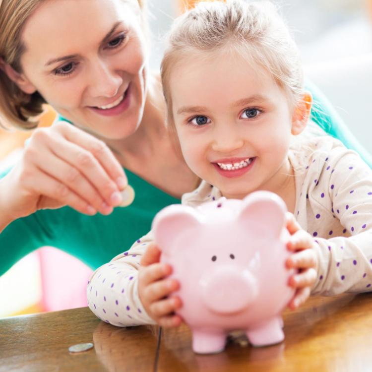 16193879 - mother and daughter putting coins into piggy bank