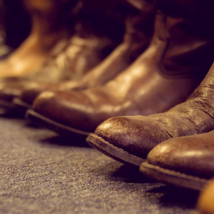 32455449 - brown vintage leather boots aligned selective focus