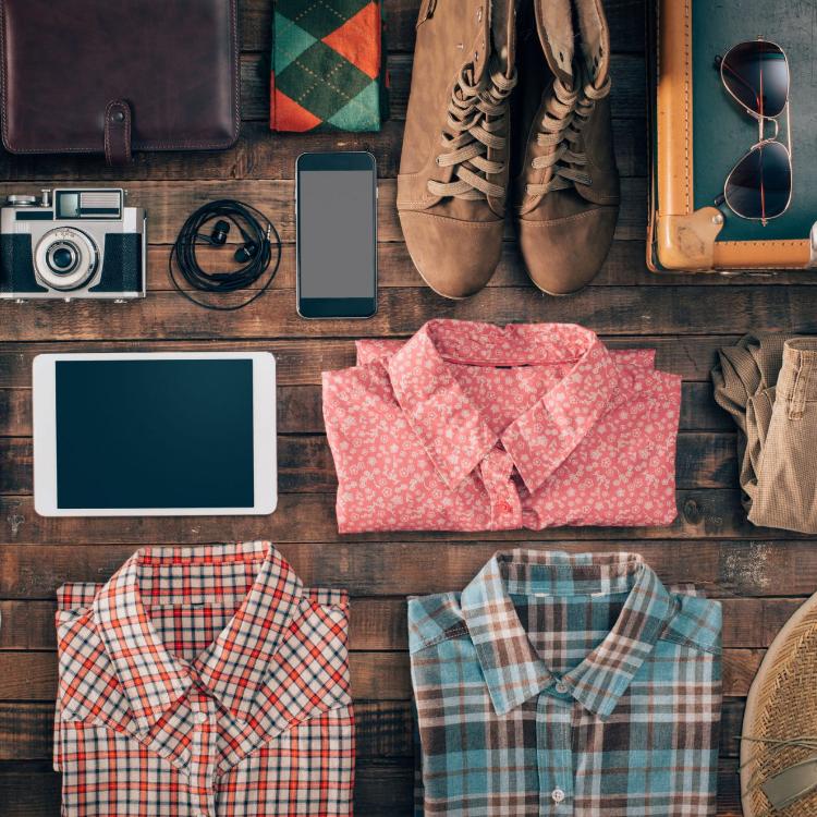 42512672 - hipster vintage accessories and clothing on a wooden table before packing, travel and vacations concept, top view