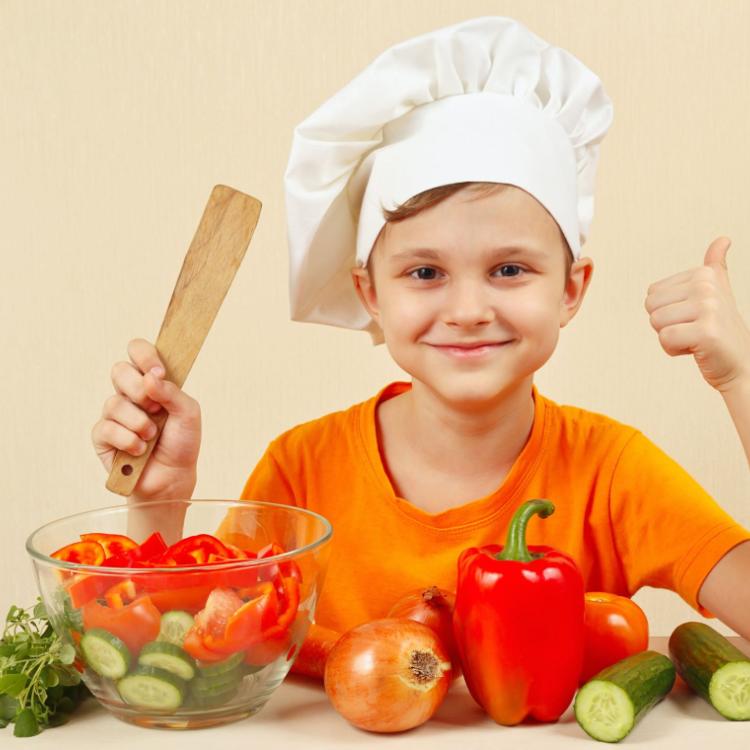 51760880 - little funny chef shows how to cook a vegetable salad
